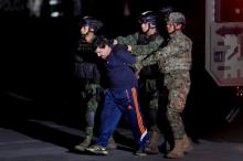 Drug lord Joaquin "El Chapo" Guzman is escorted by soldiers during a presentation in Mexico City, January 8, 2016. PHOTO BY REUTERS/Tomas Bravo