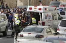 Israeli emergency personnel evacuate the body of one of the two Palestinian assailants whom police said carried out a drive-by shooting on a commuter bus in an east Jerusalem suburb before being shot dead by police opposite the Notre Dame Center just outside Jerusalem's Old City, March 9, 2016. PHOTO BY REUTERS/Ammar Awad