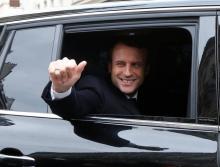 Emmanuel Macron, head of the political movement En Marche !, or Onwards !, and candidate for the 2017 presidential election, waves from his car as he leaves his home during the second round of the election, in Paris, France, May 7, 2017. PHOTO BY REUTERS/Jean-Paul Pelissier