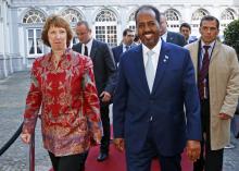 European Union foreign policy chief Catherine Ashton (L) and Somali's President Hassan Sheikh Mohamud (R) arrive at a conference called "New Deal in Somalia"