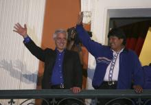 Bolivia's President Evo Morales (R) and Vice President Alvaro Garcia Linera wave to supporters from the presidential palace balcony in La Paz