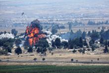An explosion is pictured at Quneitra at the Syrian side of the Israeli Syrian border, as seen from the Israeli-occupied Golan Heights, Israel, July 22, 2018. PHOTO BY REUTERS/Ronen Zvulun