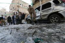 People gather at the site of a bomb explosion in Sanaa, December 23, 2014. PHOTO BY REUTERS/Khaled Abdullah