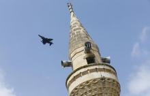 A Turkish Air Force F-4E fighter flies over a minaret after taking off from Incirlik air base in Adana, Turkey, August 12, 2015. PHOTO BY REUTERS/Murad Sezer