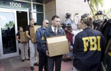 FBI agents bring out boxes after an operation inside the CONCACAF (Confederation of North, Central America and Caribbean Association Football) offices in Miami Beach, Florida, May 27, 2015. PHOTO BY REUTERS/Javier Galeano