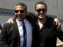 Al Jazeera television journalists Mohamed Fahmy (L) and Baher Mohamed hug as they talk to the media outside Tora prison, in Cairo, Egypt, July 30, 2015. PHOTO BY REUTERS/Asmaa Waguih