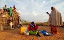 Zeinab, 14, (C) washes dishes as her mother Abdir Hussein gestures and her nephews play at a camp for internally displaced people from drought hit areas in Dollow, Somalia, April 3, 2017. PHOTO BY REUTERS/Zohra Bensemra
