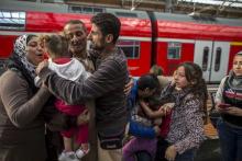 Ihab, 30 (C), a Syrian migrant from Deir al-Zor, cries as he and his family are welcomed by his relatives upon their arrival at the railway station in Lubeck, Germany, September 18, 2015. PHOTO BY REUTERS/Zohra Bensemra