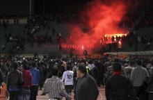 Soccer fans flee from a fire at Port Said Stadium, February 1, 2012. PHOTO BY REUTERS/Stringer
