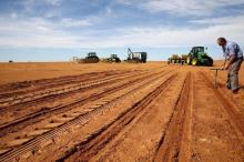A farmer inspects the soil ahead of planting at a maize field in Wesselsbron, a small maize farming town in the Free State province of South Africa, January 13, 2016. PHOTO BY REUTERS/Siphiwe Sibeko