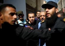 A member of Fatah movement is escorted by members of Palestinian security forces loyal to Hamas upon his release from a Hamas-run jail as part of reconciliation efforts, in Gaza City, October 1, 2017. PHOTO BY REUTERS/Mohammed Salem