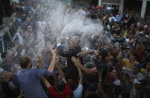 Hamas spokesman Fawzi Barhoum (C) is carried by Palestinians as they celebrate what they said was a victory over Israel, following a ceasefire in Gaza City