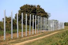 The poles of a new fence on the border with Croatia are set up near Beremend, Hungary, September 21, 2015. PHOTO BY REUTERS/Bernadett Szabo