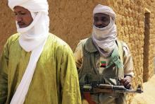 A fighter with the Tuareg separatist group MNLA (National Movement for the Liberation of Azawad) stands guard outside the local regional assembly, where members of the rebel group met with the Malian army, the UN mission in Mali and French army officers, in Kidal