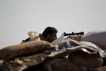 A Free Syrian Army fighter of the 101 Division takes a position behind sandbags near the town of Morek in the northern countryside of Hama, Syria, October 14, 2015. PHOTO BY REUTERS/Khalil Ashawi