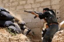 A Jaysh al-Islam (Army of Islam) rebel fighter fires his weapon towards forces loyal to Syria's President Bashar Al-Assad at the Tal-Kurdi frontline in the Eastern Ghouta of Damascus, May 10, 2015. PHOTO BY REUTERS/Amer Almohibany