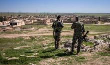Kurdish People's Protection Units (YPG) fighters stand with their weapons in Tel Hamis in Hasaka countryside, March 1, 2015. PHOTO BY REUTERS/Rodi Said