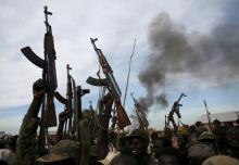 Rebel fighters hold up their rifles in Upper Nile State, South Sudan. PHOTO BY REUTERS/Goran Tomasevic