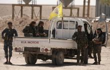 Fighters from Deir al-Zor military council which fights under the Syrian Democratic Forces (SDF) sit on a back of a truck in the village of Abu Fas, Hasaka province, Syria, September 9, 2017. PHOTO BY REUTERS/Rodi Said