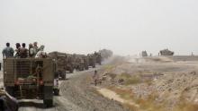 Fighters loyal to Yemen's President Abd-Rabbu Mansour Hadi ride on armoured personnel carrier vehicles on a road leading to the al-Anad military and air base in the country's southern province of Lahej, August 3, 2015. PHOTO BY REUTERS/Stringer