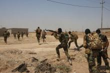Asaib Ahl al-Haq Shi'ite militia fighters from the south of Iraq run during a mission to take control of Sulaiman Pek village from Islamist State militants, in the northwest of Tikrmt city, September 1, 2014. PHOTO BY REUTERS/Youssef Boudlal