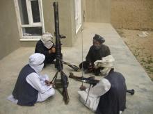 Taliban fighters pose with weapons as they sit in their compound at an undisclosed location in southern Afghanistan in this May 5, 2011 file picture. PHOTO BY REUTERS/Stringer