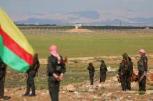 Kurdish members of the Self-Defense Forces stand near the Syrian-Turkish border in the Syrian city of al-Derbasiyah during a protest against the operations launched in Turkey by government security forces against the Kurds, February 9, 2016. PHOTO BY REUTERS/Rodi Said