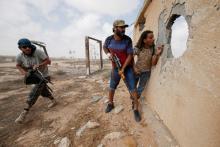 Libyan forces allied with the U.N.-backed government take cover during a battle with Islamic State fighters in Sirte, Libya, July 15, 2016. PHOTO BY REUTERS/Goran Tomasevic