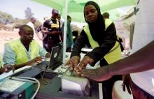 Officials from the Independent Electoral and Boundaries Commission (IEBC) records finger prints of a man as they collect data from the electorate during the launch of the 2017 general elections voter registration exercise within Kibera slums in Kenya's capital Nairobi, January 16, 2017. PHOTO BY REUTERS/Thomas Mukoya