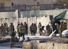 Afghan fire-fighters and members of security forces clean the site of a suicide attack in Kabul, Afghanistan, February 1, 2016. PHOTO BY REUTERS/Omar Sobhani