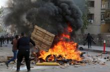 Demonstrators set tyres on fire as they clash with riot police during a protest against the curfew in Sur district, in the southeastern city of Diyarbakir, Turkey, December 14, 2015. PHOTO BY REUTERS/Sertac Kayar
