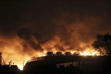 Vehicles are seen burning after blasts at Binhai new district in Tianjin municipality, China, August 13, 2015. PHOTO BY REUTERS/Stringer