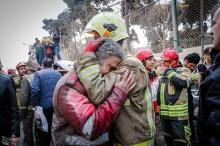 Firefighters react at the site of a collapsed high-rise building in Tehran, Iran, January 19, 2017. PHOTO BY REUTERS/Tasnim News Agency