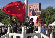 A paramilitary policeman unfurls a Chinese national flag during a flag raising ceremony at the celebrations event marking the 50th anniversary of the founding of the Tibet Autonomous Region, in Lhasa, Tibet Autonomous Region, China, September 8, 2015. PHOTO BY REUTERS/China Daily