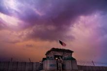 A U.S. Marine from the First Battalion Eighth Marines Alpha Company looks out as an evening storm gathers above an outpost near Kunjak in southern Afghanistan's Helmand province, February 22, 2011. PHOTO BY REUTERS/Finbarr O'Reilly