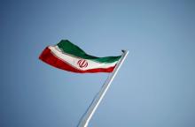 An Iranian national flag flutters during the opening ceremony of the 16th International Oil, Gas & Petrochemical Exhibition (IOGPE) in Tehran, April 15, 2011. PHOTO BY REUTERS/STR