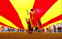 People walk under a huge Catalan flag during Spain's National Day in Barcelona. PHOTO BY REUTERS/Gonzalo Fuentes