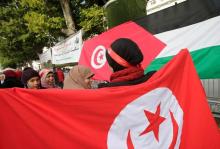A woman carries a Tunisian flag during demonstrations on the seventh anniversary of the toppling of president Zine El-Abidine Ben Ali, in Tunis, Tunisia, January 14, 2018. PHOTO BY REUTERS/Youssef Boudlal