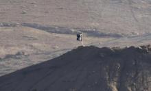 A black flag belonging to the Islamic State is seen near the Syrian town of Kobani, as pictured from the Turkish-Syrian border near the southeastern town of Suruc in Sanliurfa province, October 6, 2014. PHOTO BY REUTERS/Umit Bektas