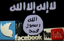 A 3D plastic representation of the Twitter and Youtube logo is seen in front of a displayed ISIS flag in this photo illustration in Zenica, Bosnia and Herzegovina, February 3, 2016. PHOTO BY REUTERS/Dado Ruvic