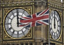 A British Union Jack flag is flying near a face of the clocktower at the Houses of Parliament in London, Britain, February 1, 2016. PHOTO BY REUTERS/Toby Melville