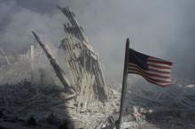 An American flag flies near the base of the destroyed World Trade Center in New York, in this file photo from September 11, 2001, taken after the collapse of the towers. PHOTO BY REUTERS/Peter Morgan