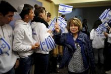 A Jewish immigrant from France arrives for a candle-lighting ceremony to mark the Jewish holiday of Hanukkah, upon landing at Ben Gurion International Airport near Tel Aviv, Israel, December 8, 2015. PHOTO BY REUTERS/Amir Cohen