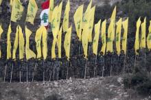 Members of Lebanon's Hezbollah wave Hezbollah and Lebanese flags during a rally marking the ninth anniversary of the end of Hezbollah's 2006 war with Israel, in Wadi al-Hujeir, southern Lebanon, August 14, 2015. PHOTO BY REUTERS/Aziz Taher