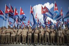 Members of the Cuban Revolutionary Army hold Cuban national flags during a march "For the Five and Against the Terrorism" in Havana, September 30, 2014. PHOTO BY REUTERS/Alexandre Meneghini