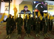 Members of Lebanon's Hezbollah wave flags after Hezbollah leader Sayyed Hassan Nasrallah addressed them from a screen in Beirut's southern suburbs, Lebanon, May 20, 2016. PHOTO BY REUTERS/Aziz Taher