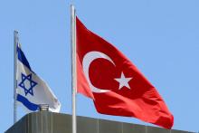 A Turkish flag flutters atop the Turkish embassy as an Israeli flag is seen nearby, in Tel Aviv, Israel, June 26, 2016. PHOTO BY REUTERS/Baz Ratner