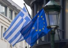 A Greek (L) and a European flag flutter outside the Greek embassy in Brussels, February 19, 2015. PHOTO BY REUTERS/Yves Herman