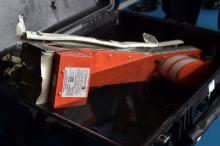 The flight data recorder of AirAsia QZ8501 is seen in a carrying case onboard Indonesian navy vessel KRI Banda Aceh, in the Java Sea, January 12, 2015. PHOTO BY REUTERS/Adek Berry