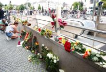 A women places flowers near the Olympia shopping mall, where yesterday's shooting rampage started, in Munich, Germany, July 23, 2016. PHOTO BY REUTERS/Arnd Wiegmann